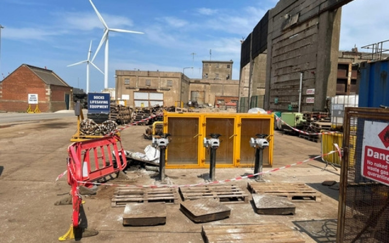 Dockside sewer infrastructure installation with sluice gate actuators and safety barriers