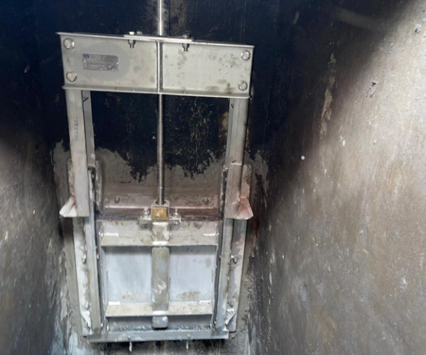 AWS-Flush Sluice gate installed in a sewer channel for automated sediment flushing.