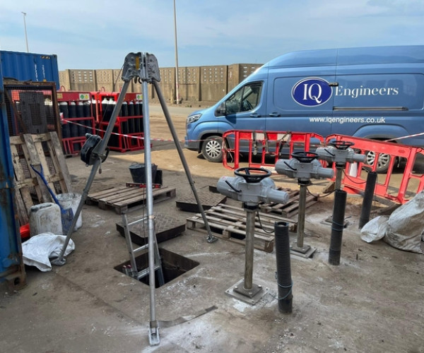 Sluice gate installation site with operating gear and tripod hoist, managed by IQ Engineers.